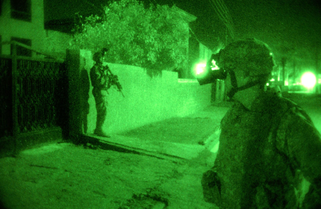 BAGHDAD  Col. Michael Beech, commander, 4th Brigade Combat Team, 4th Infantry Division, makes assessments while Sgt. Jeffrey Rogers, command personal security detachment team leader, pulls security during a mission with a platoon from the 2nd Battalion, 506th Regimental Combat Team, 101st Airborne Division. (U.S. Army photo by Staff Sgt. Brent Williams, 4th BCT PAO, 4th Inf. Div.)